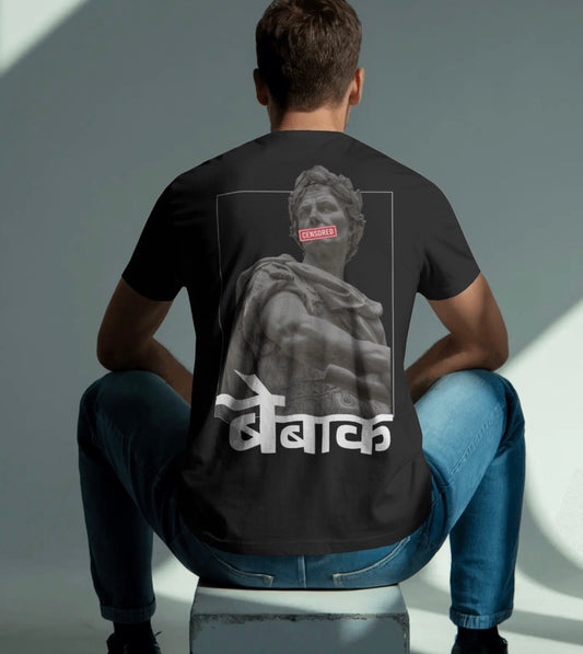 Person wearing a black t-shirt with a statue graphic and text on the back, sitting against a gray background.