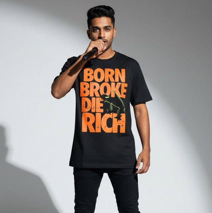 Person wearing a black t-shirt with orange text on a gray background