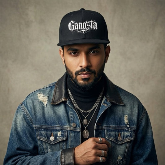 rapper wearing a denim jacket and 'Gangsta' cap against a neutral background