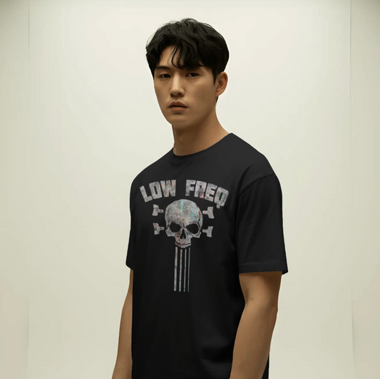 Person wearing a black t-shirt with a graphic design on a plain background