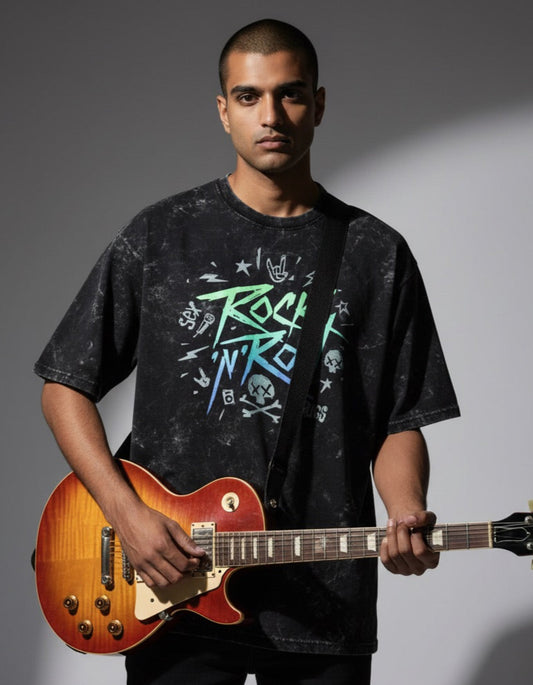 Man holding a guitar wearing a 'Rock N Roll' t-shirt against a gray background