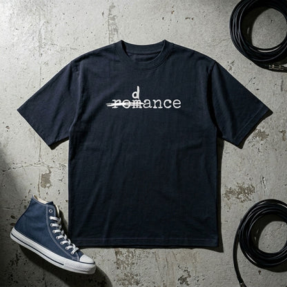 Drummerkong oversized dancer t-shirt with 'dance' text on a textured surface with a blue sneaker.