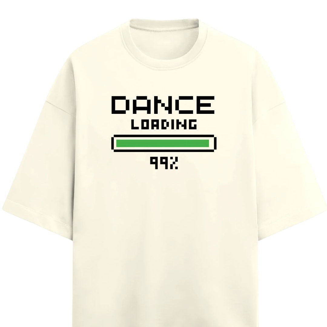 Drummerkong merchandise off-white short-sleeve t-shirt with a pixel-art style graphic on the chest reading 'DANCE LOADING 99%'. The graphic features black text and a green progress bar, set against a plain white background.