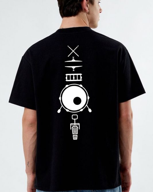 Person wearing a black t-shirt with white drum design on the back against a plain background