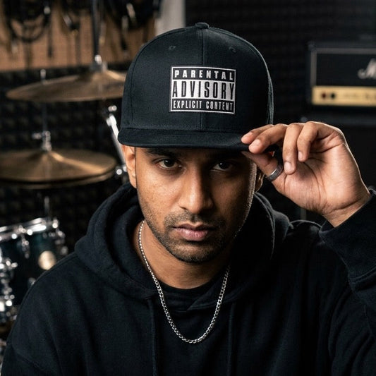 rapper wearing drummerkong snapback cap with parental advisory label