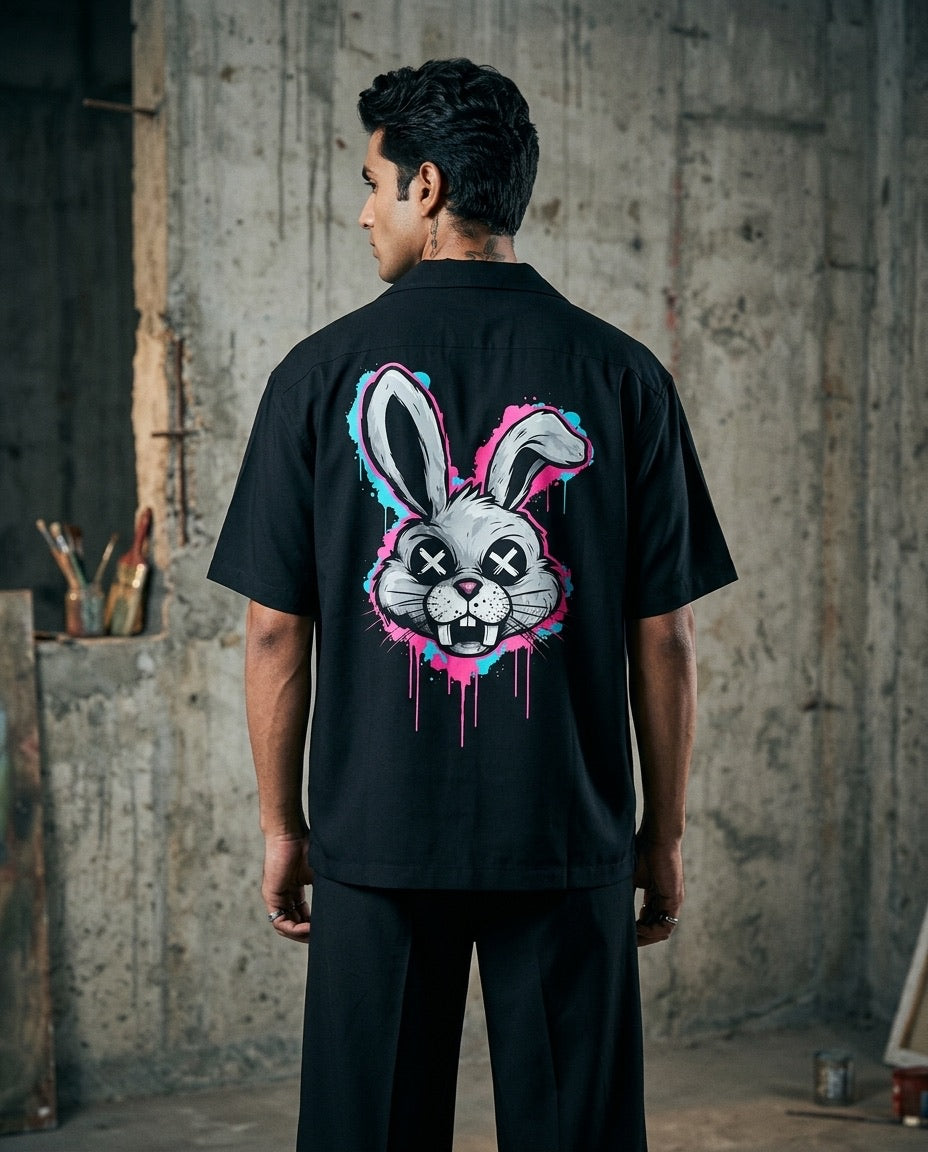 Person wearing a black t-shirt with a graphic design of a playboy rabbit on the back
