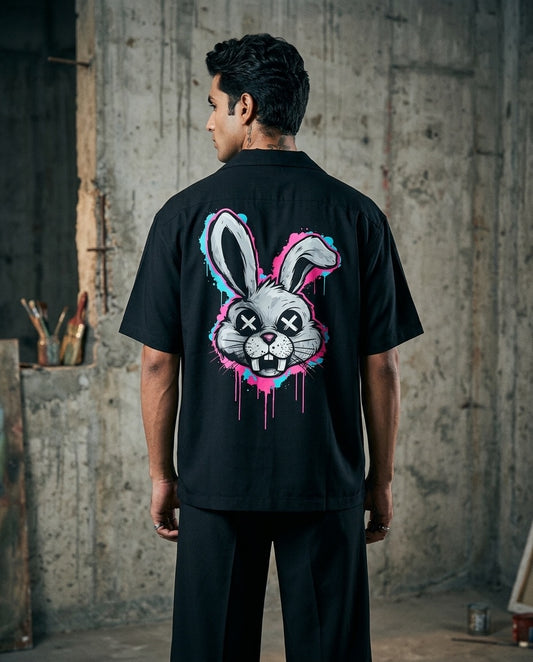 Person wearing a black t-shirt with a graphic design of a playboy rabbit on the back