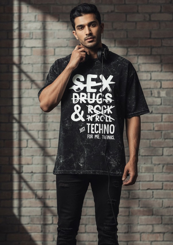 Man wearing a black t-shirt with white text against a brick wall.